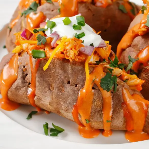 Air fryer loaded sweet potatoes recipe. Looking for a healthy alternative to fried potatoes? Try these baked sweet potatoes loaded with Cheddar cheese, sour cream, and red onions. #airfryer #dinner #potatoes #easy #healthy