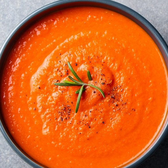 Slow cooker sweet red pepper soup recipe. This soup is a hearty, comforting meal that only takes a few hours to make. It's packed with fire-roasted sweet red peppers, fresh tomato juice, and spices. #slowcooker #crockpot #soups #vegetarian #vegan #healthy #dinner