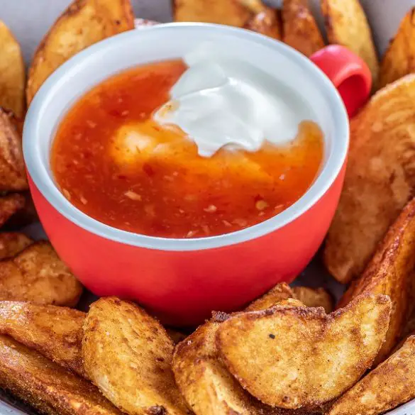 Air fryer potato wedges with sweet chili sauce. Perfectly air-fried potato wedges are ready to serve in just over 30 minutes. They are so easy and tasty. You won't regret trying them out! #airfryer #appetizers #party #dinner #vegetarian #vegan #glutenfree